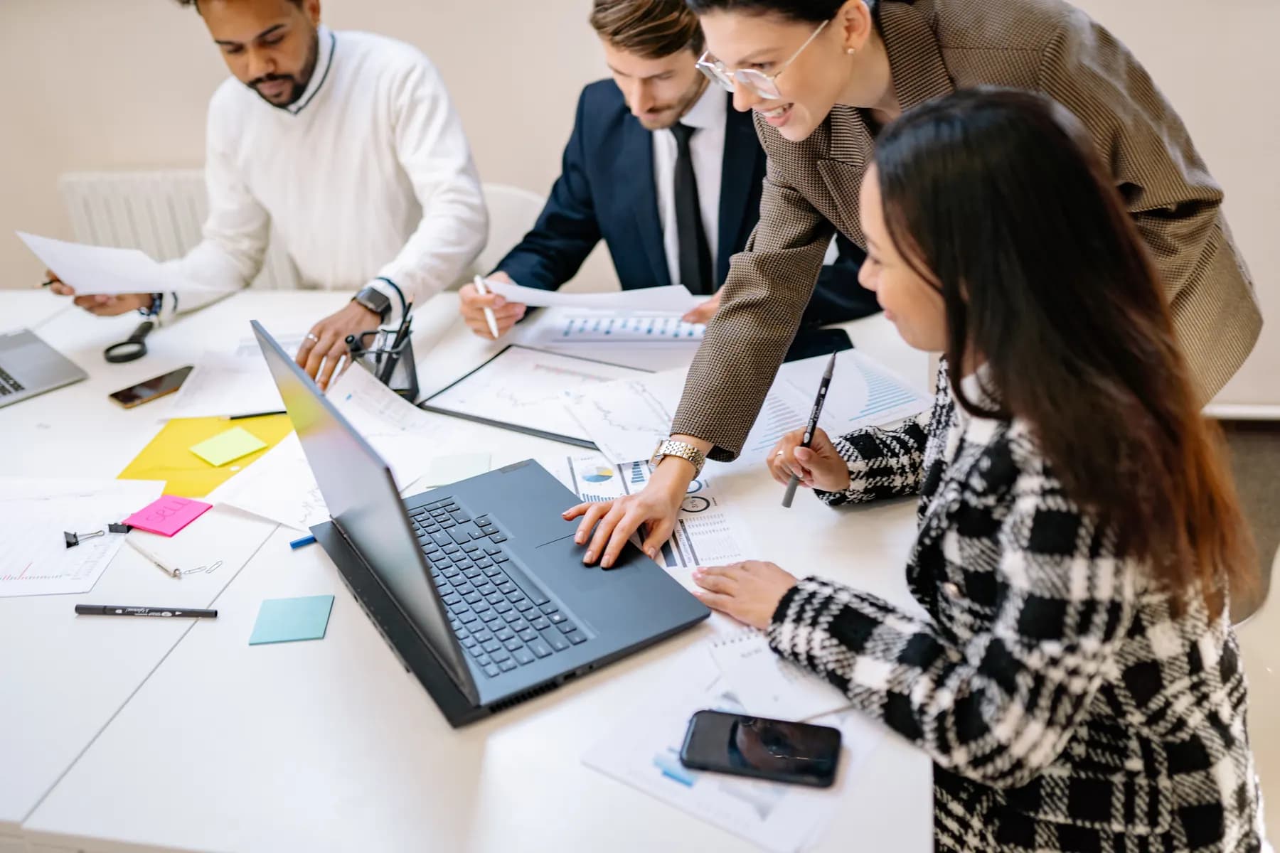 Three sales colleagues reviewing a proposal together